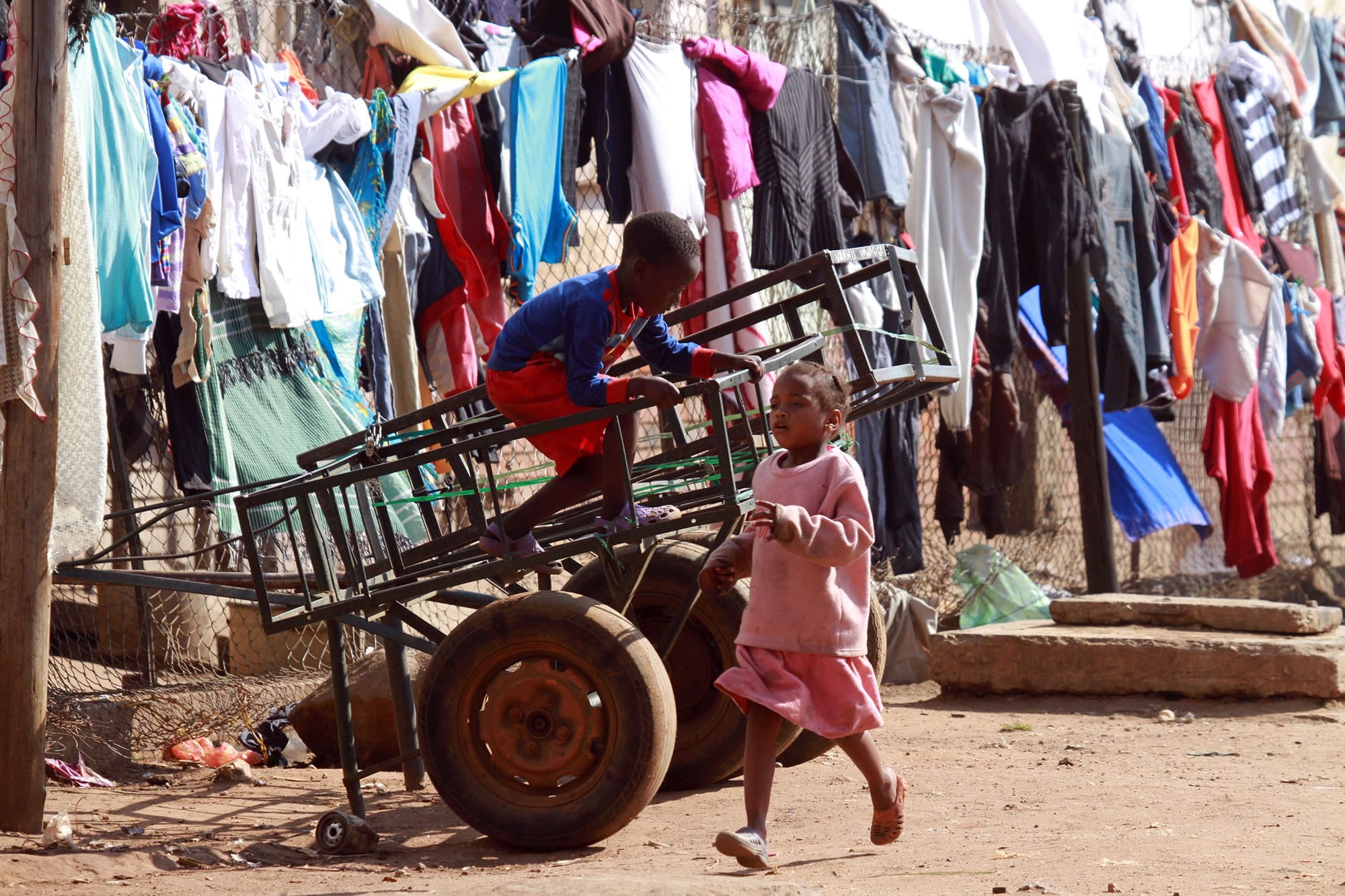 Children play near laundry hanging on a line in Mbare, Harare on Thursday.