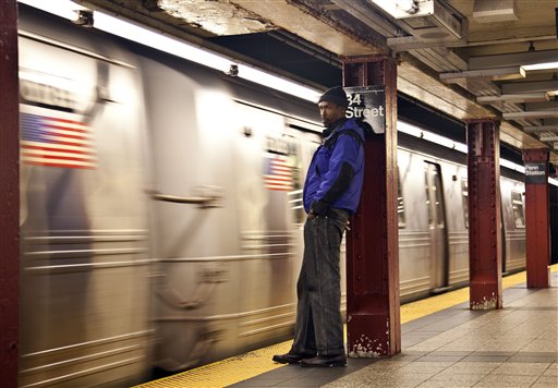 A commuter waits as the first A train approaches the platform at Penn Station as Metropolitan Transit Authority resumed limited service Thursday in New York.