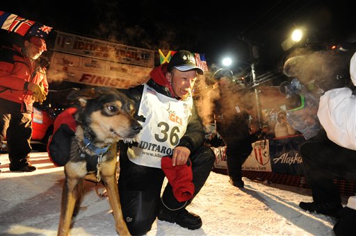 Mitch Seavey became the oldest winner and a two-time Iditarod champion when he drove his dog team under the burled arch in Nome on Tuesday evening, March 12, 2013.