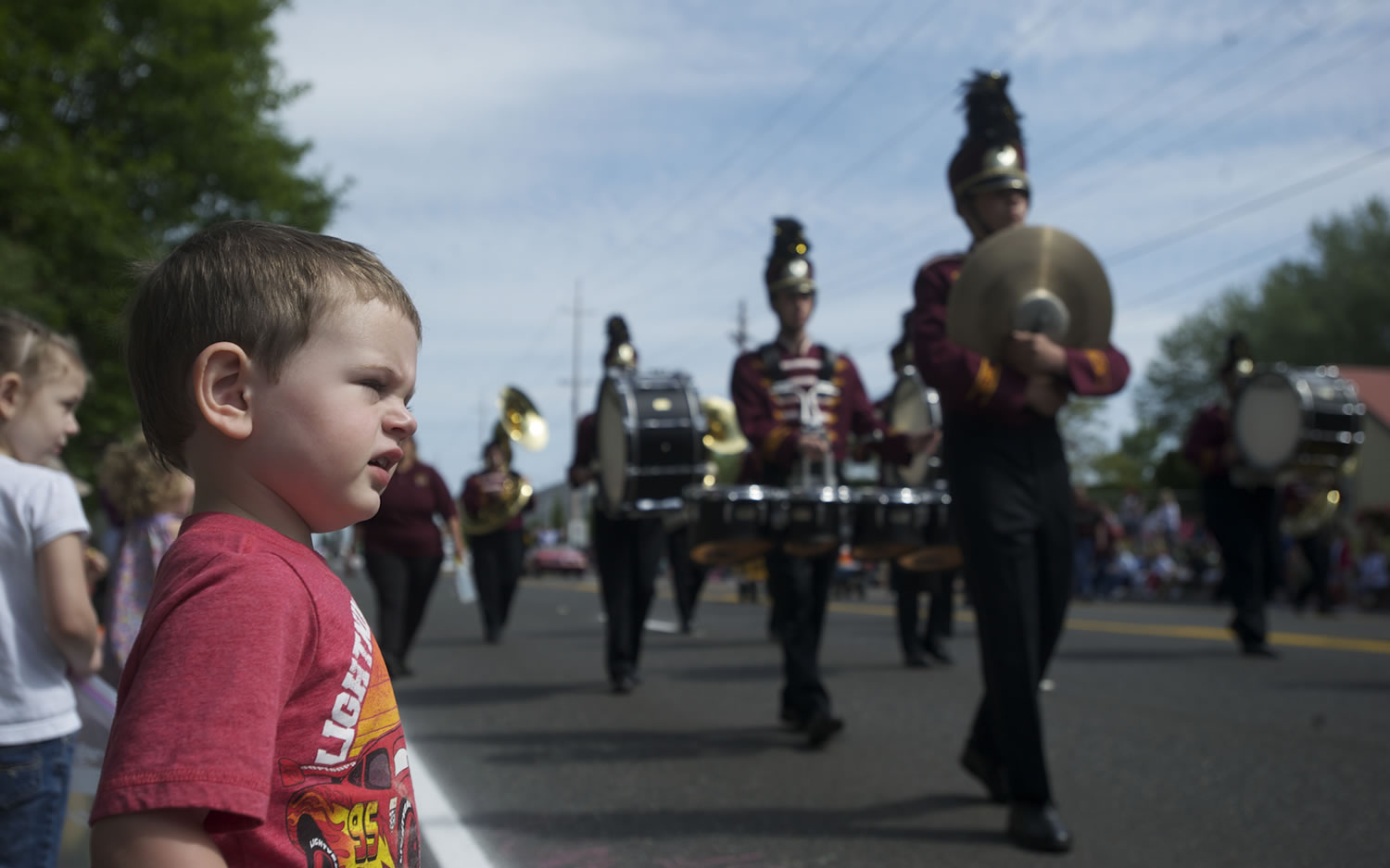 Alexander Voukidis, 23 months, watches the Moses Lake High School band pass at the 48th annual Hazel Dell Parade of Bands.