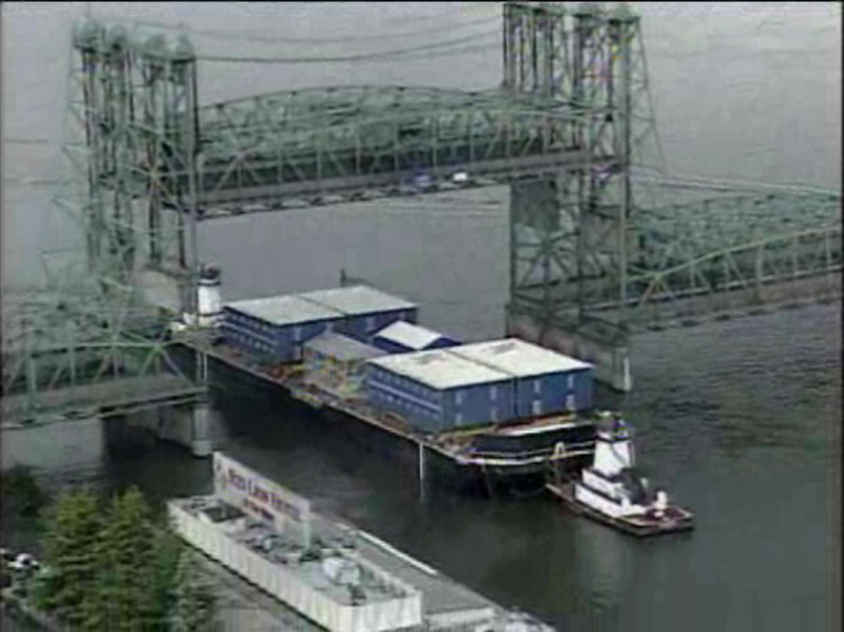 A barge loaded with equipment destined for Alaska passes through the Interstate 5 Bridge earlier this year.