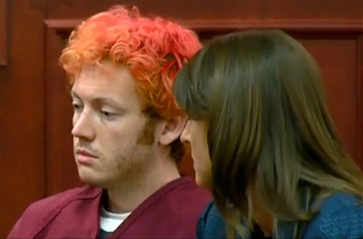 James Holmes, left, the suspected gunman in the Colorado theater massacre on Friday, July 20, makes his first appearance in court with his attorney on Monday, July 23 in Aurora, Colo.