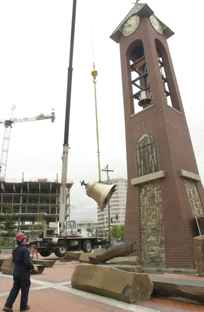 Don Swem watches as a cast bronze bell is lifted to the Salmon Run Bell Tower at Esther Short Park when it was first installed in 2002. The tower is still using the same computer system, which is why the clock marked the end of daylight saving time a week early this year. Congress changed the end of daylight saving time from October to November in 2007.