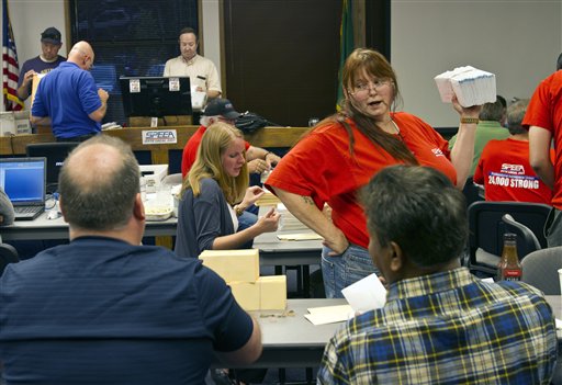 Boeing engineering union member Linda Maynard, right, explains valid ballots to union members counting ballots on the company's latest contract proposal, Monday in Tukwila.