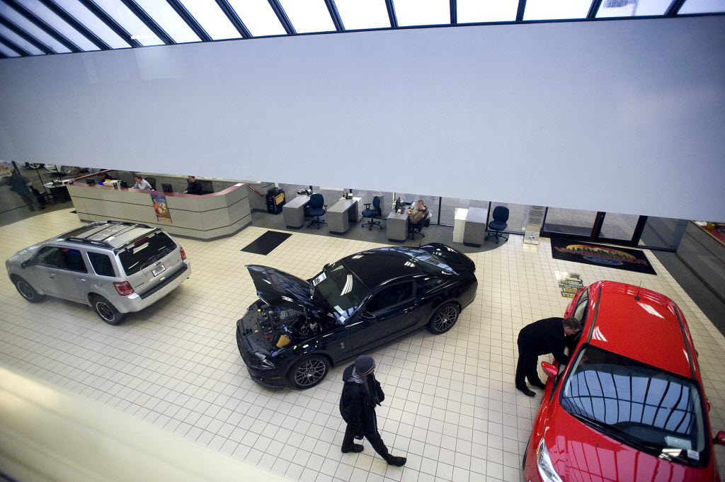 Sales personnel at Vancouver Ford wait to assist customers inside the showroom in January.