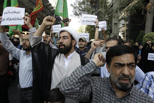 Iranian protestors chant slogans during a demonstration against a film ridiculing Islam's Prophet Muhammad, in front of Swiss Embassy in Tehran, which represents US interests in Iran, Thursday, Sept.