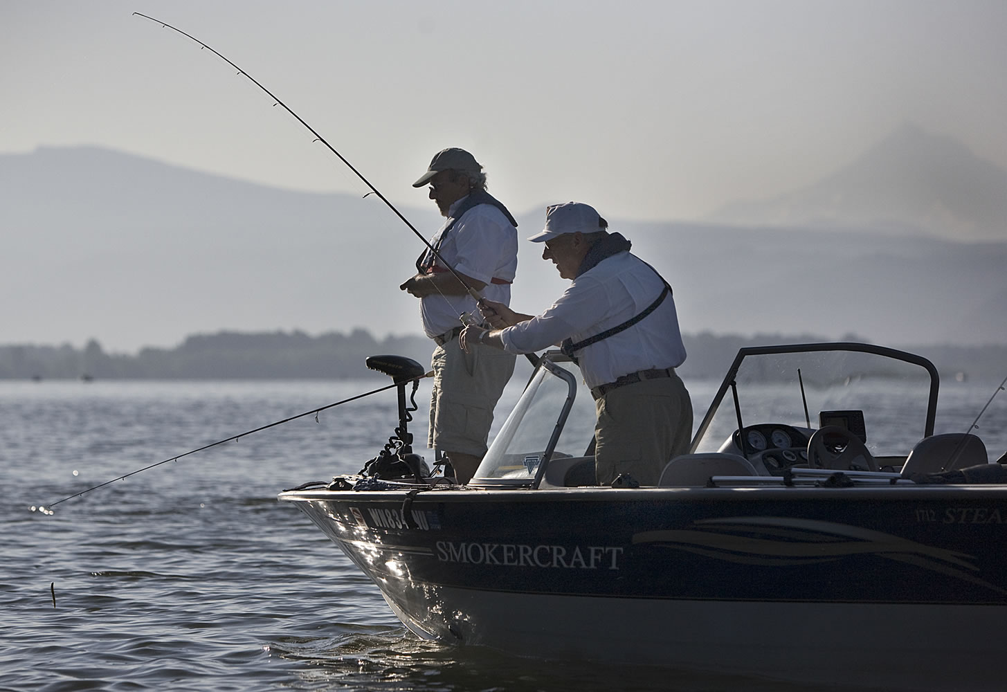 Jim Liddell, left, of Vancouver and Bud Hartman of Portland fish for bass near Government Island.