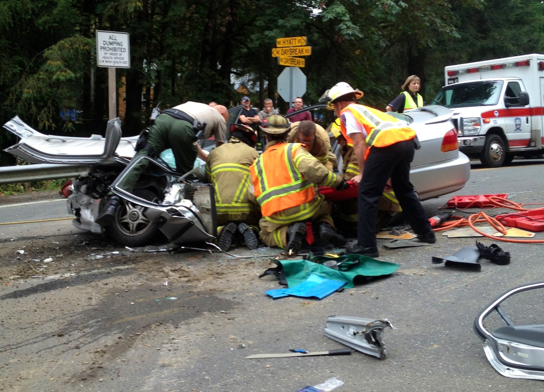Rescuers aid a woman injured Thursday in a head-on collision near Daybreak Park.
