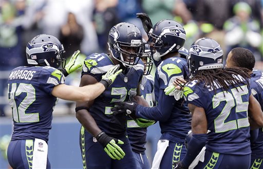 Seattle Seahawks' Kam Chancellor (31) is congratulated by teammates after intercepting against the Jacksonville Jaguars in the second half Sunday in Seattle.