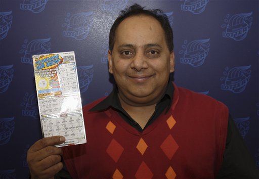 Urooj Khan, 46, poses with a winning lottery ticket.
