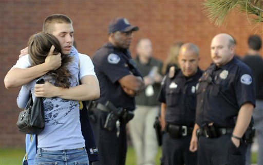 Eyewitness Jacob Stevens, 18, hugs his mother Tammi Stevens after being interview by police outside Gateway High School where witnesses were brought for questioning today in Aurora, Colo.