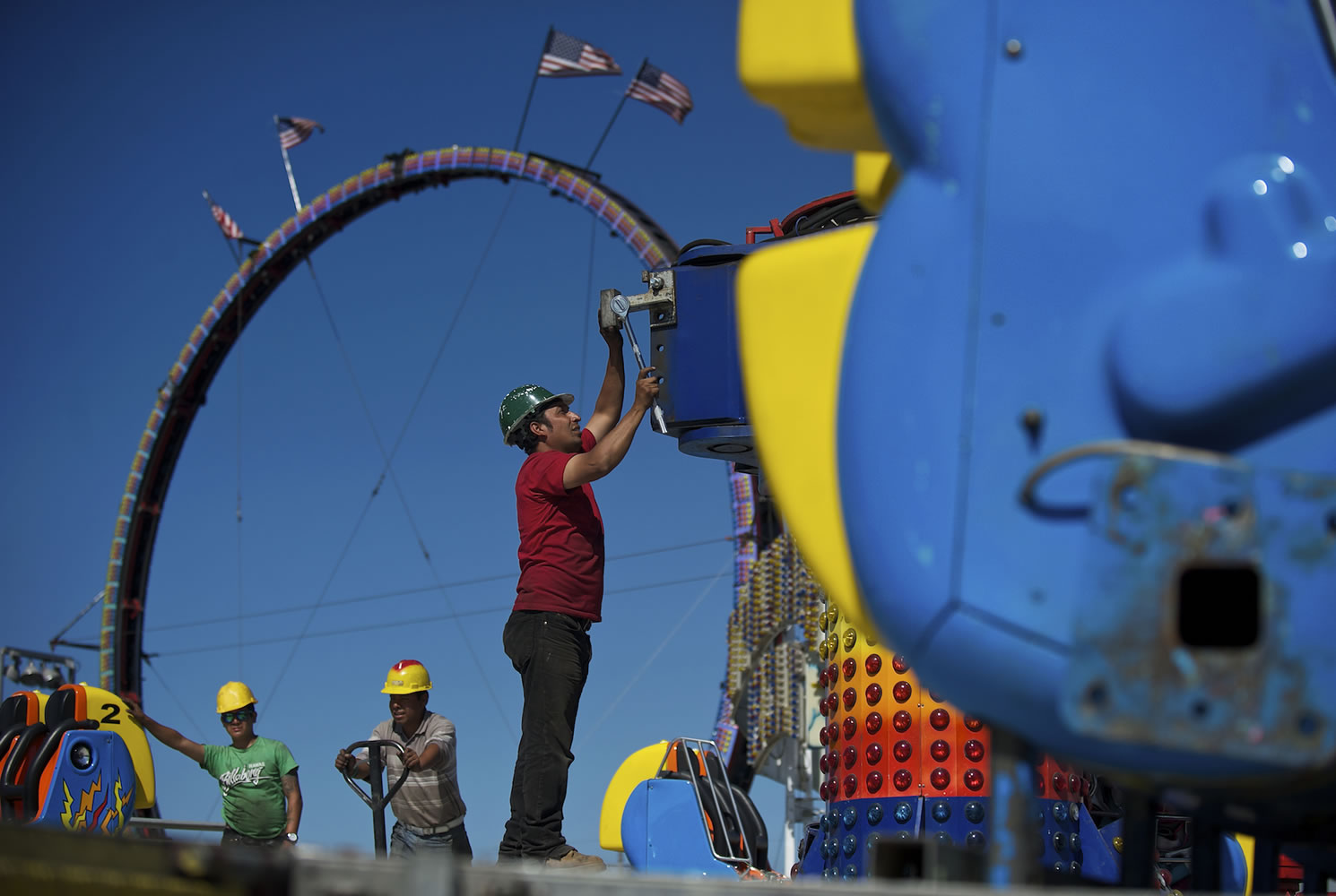 Workers assemble carnival rides Aug.