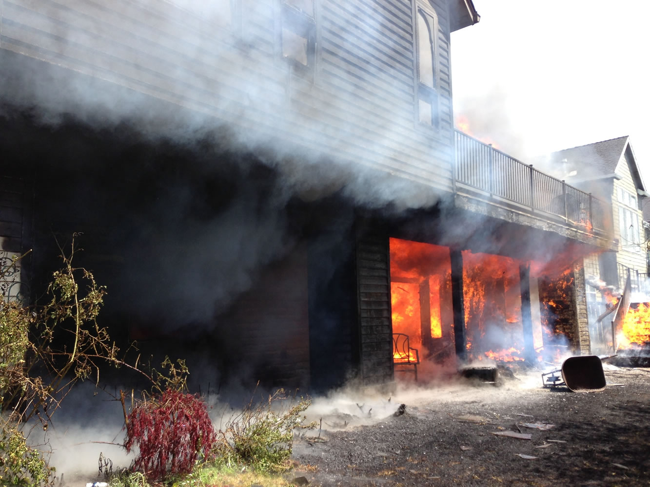 Fire licks out from the daylight basement of a home on Northwest Sierra Drive in Camas.