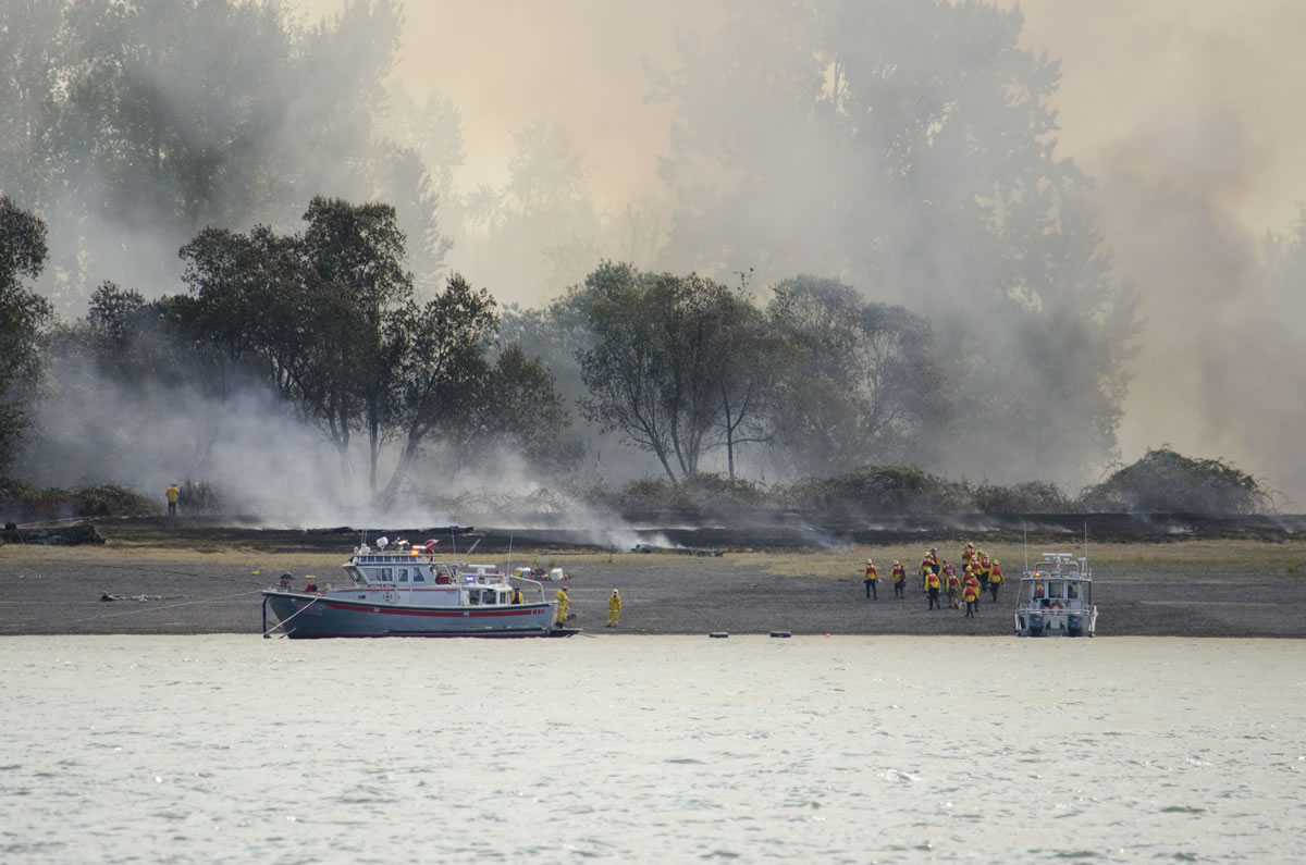 Firefighters arrive at Government Island Monday afternoon, Aug.