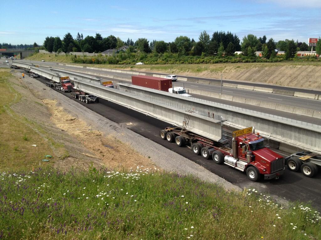 A parade of semi-tractor trailers with giant concrete girders is lined up and ready Friday for this weekend's shutdown of Interstate 5 for the Salmon Creek Interchange Project.