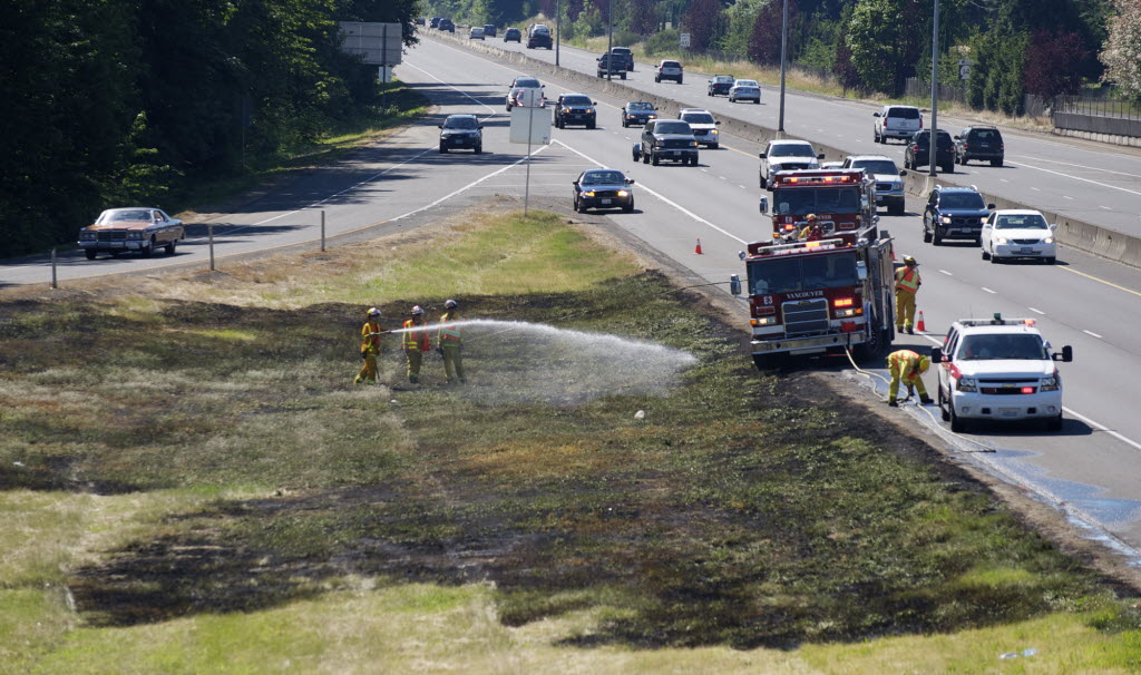 Firefighters with the Vancouver Fire Departmaent respond to a grass fire along Highway 14 eastbound at Exit 4 near Ellsworth Road in late June.