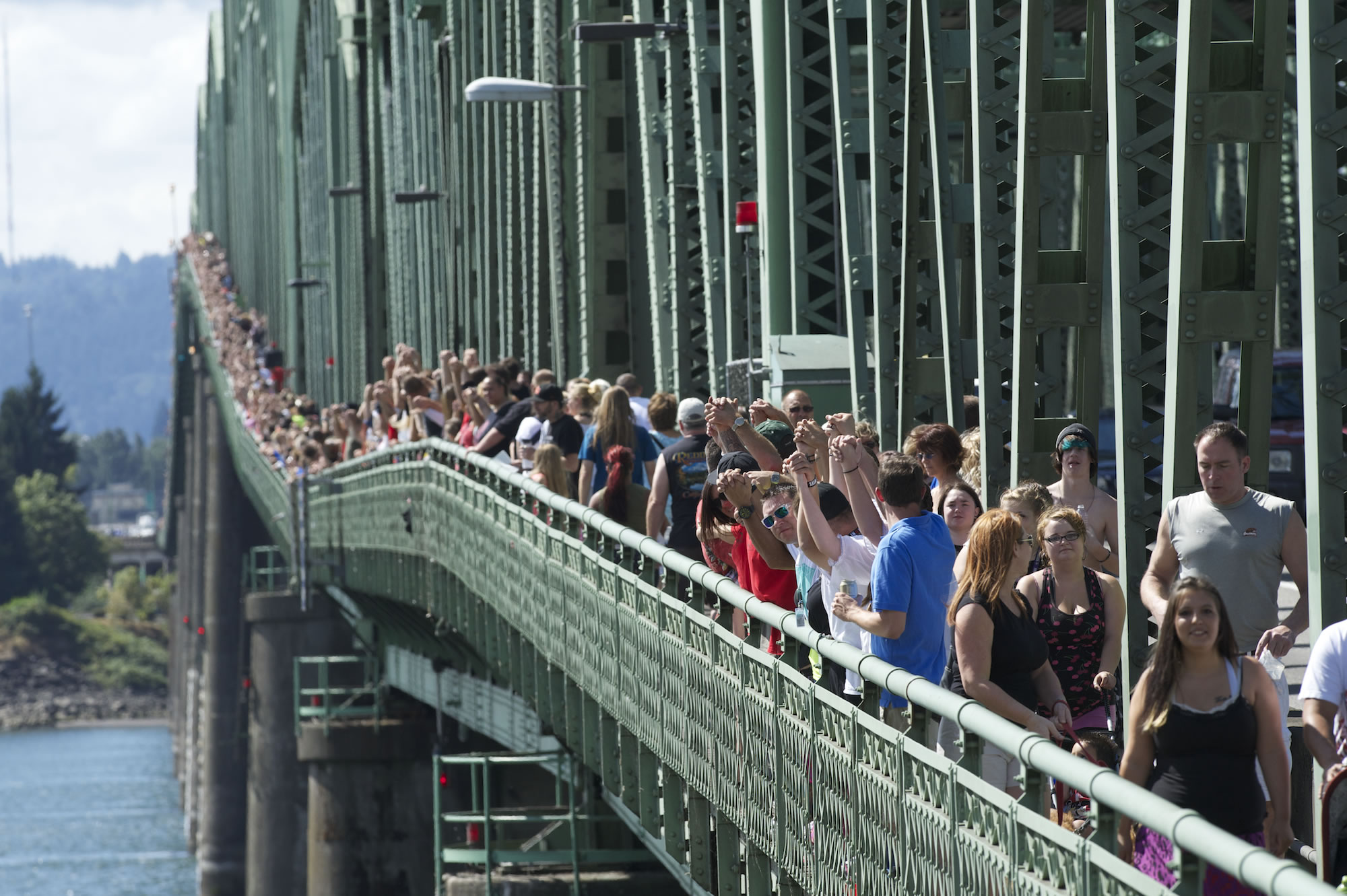 Thousands gather on the pedestrian sidewalk of the Interstate 5 Bridge on Sept. 2, 2013, joining hands and cheering their recovery from drug addiction. The 12th annual Hands Across the Bridge event marked the beginning of National Recovery Month. Hands Across the Bridge will be on Sept.