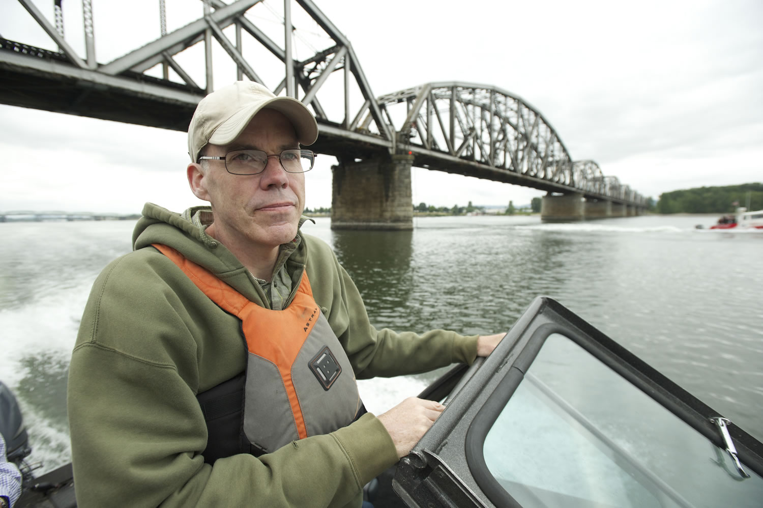 Environmental activist Bill McKibben passes under the Vancouver Railroad Bridge during a boat tour of  the Columbia River and the crude oil site proposed for the Port of Vancouver on Wednesday.