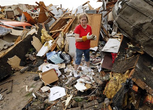 JoAnn Anderson sorts through the rubble of her home after a tornado on Monday in Moore, Okla. A monstrous tornado roared through the Oklahoma City suburbs, flattening entire neighborhoods with winds up to 200 mph, setting buildings on fire and landing a direct blow on an elementary school.