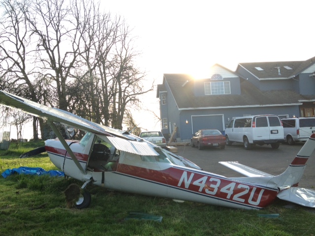 A Cessna 150 sits near the Brush Prairie home of Mark and Angela Congdon, where it crashed while trying to land at Brush Prairie Aerodrome about 5:15 p.m.