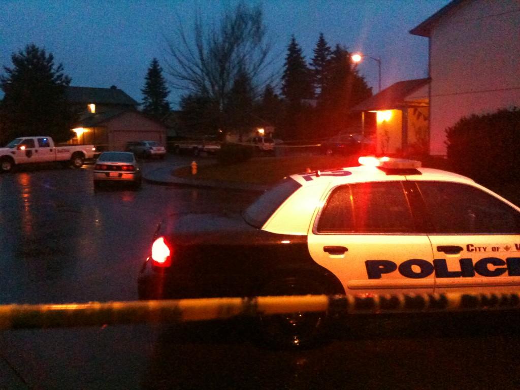 Police cars and crime scene tape surround a neighborhood where a resident shot an intruder early today.