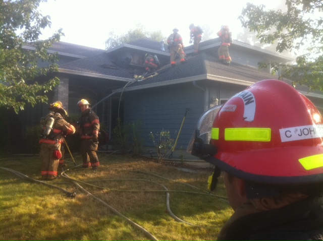 Vancouver firefighters work to extinguish a house fire at 18602 S.E.