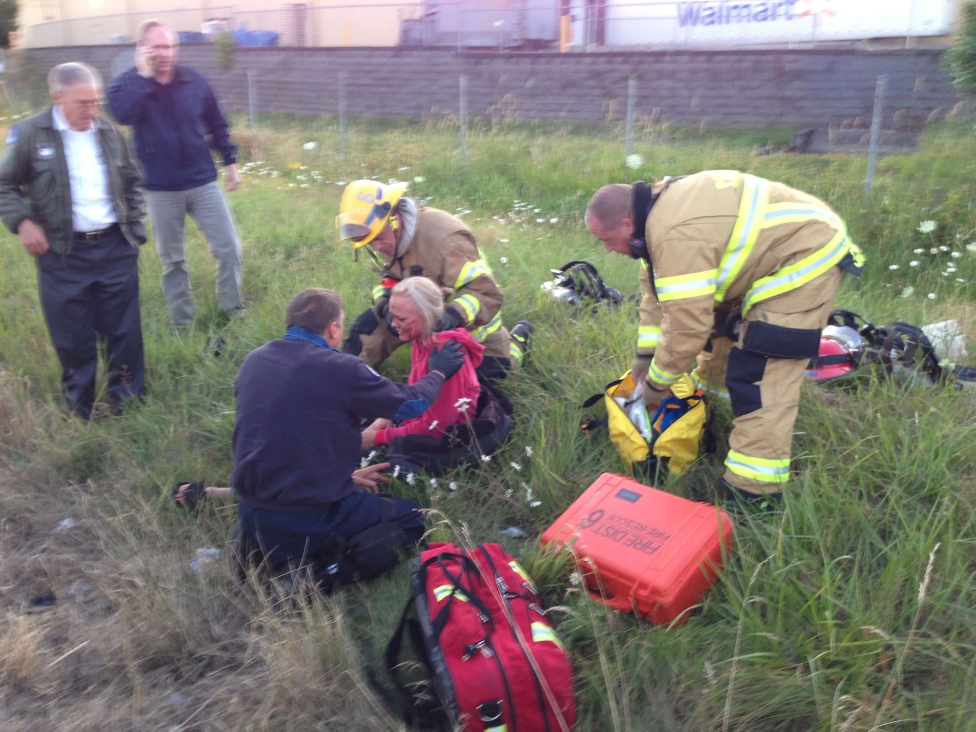 Rescuers tend to an injured woman after an accident on Interstate 5 near Northeast 99th Street early Saturday.