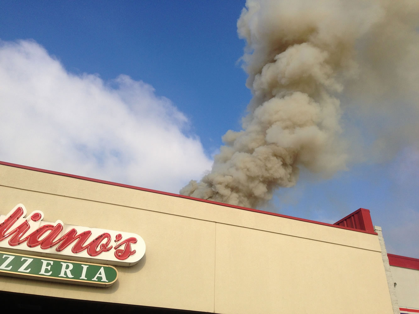 Smoke billows from a pizza oven chimney at Juliano's Pizzeria on Southeast Mill Plain Boulevard early Saturday afternoon.
