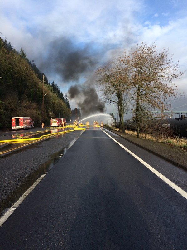 Firefighters put out a fire that sparked when a tractor-trailer and a train collided in Northwest Portland on Sunday morning. The truck's driver died, police said.