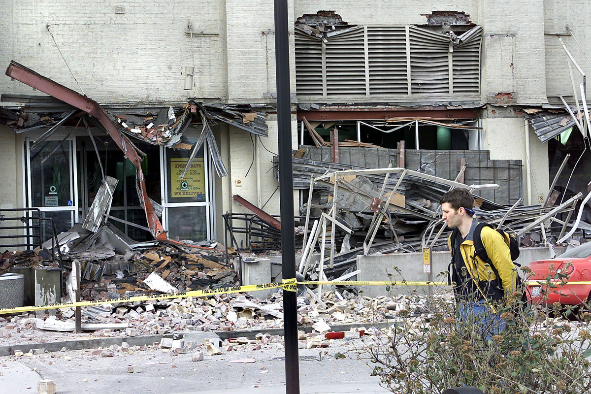 The Seattle Times files
A man walks by a damaged Starbucks in Seattle after the 2001 Nisqually earthquake. The magnitude 6.8 earthquake could be small compared with a potential quake in the Cascadia fault zone. The zone created a magnitude 9.0 earthquake when it last ruptured in 1700.