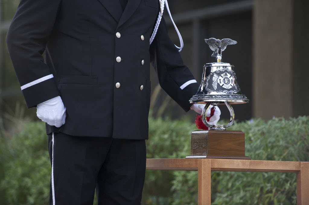 Vancouver Fire Captain Perry LeDoux rings a bell in remembrance of those who lost their lives in the 9/11 attacks during a ceremony at Vancouver City Hall.