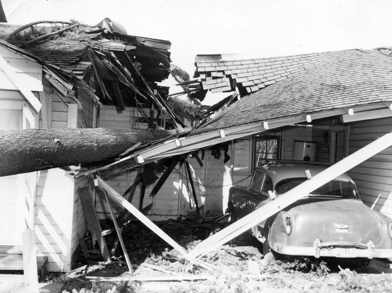 Files/The Columbian
A namesake tree at Fir Grove Auto Trailer Court at 46th and Main streets crashed through a garage roof during the Columbus Day Storm in 1962.