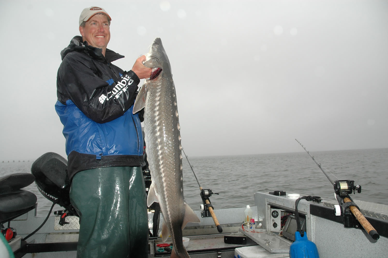 Guide Bob Rees holds a sturgeon caught near Hammond, Ore., at the mouth of the Columbia River last June.