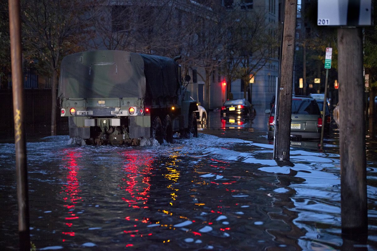A National Guard truck drives through high water on Newark Street in Hoboken, N.J. Wednesday, Oct. 31, 2012 in the wake of superstorm Sandy.