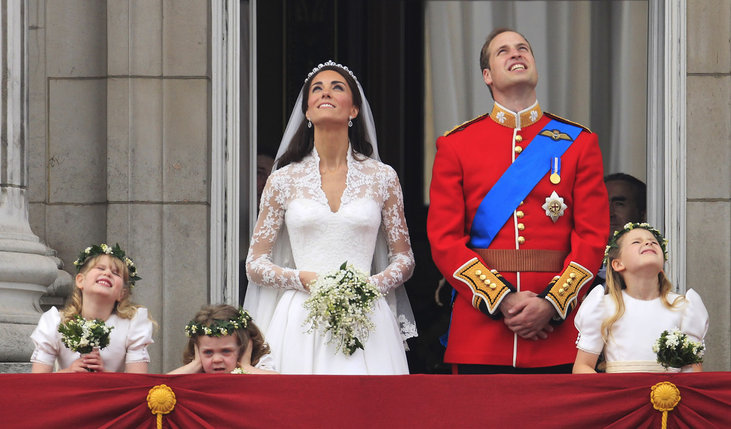 Britain's Prince William and his wife Kate, Duchess of Cambridge watch a fly past of military planes from the balcony of Buckingham Palace after the Royal Wedding in London Friday, April, 29, 2011.