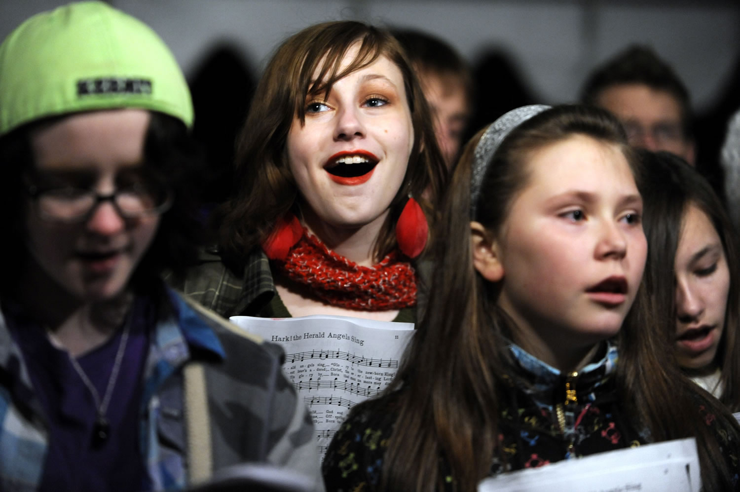 Laura Hoekstra, center, sings carols with the Vancouver Schools Choir prior to the 2011 Christmas tree lighting at Esther Short Park.