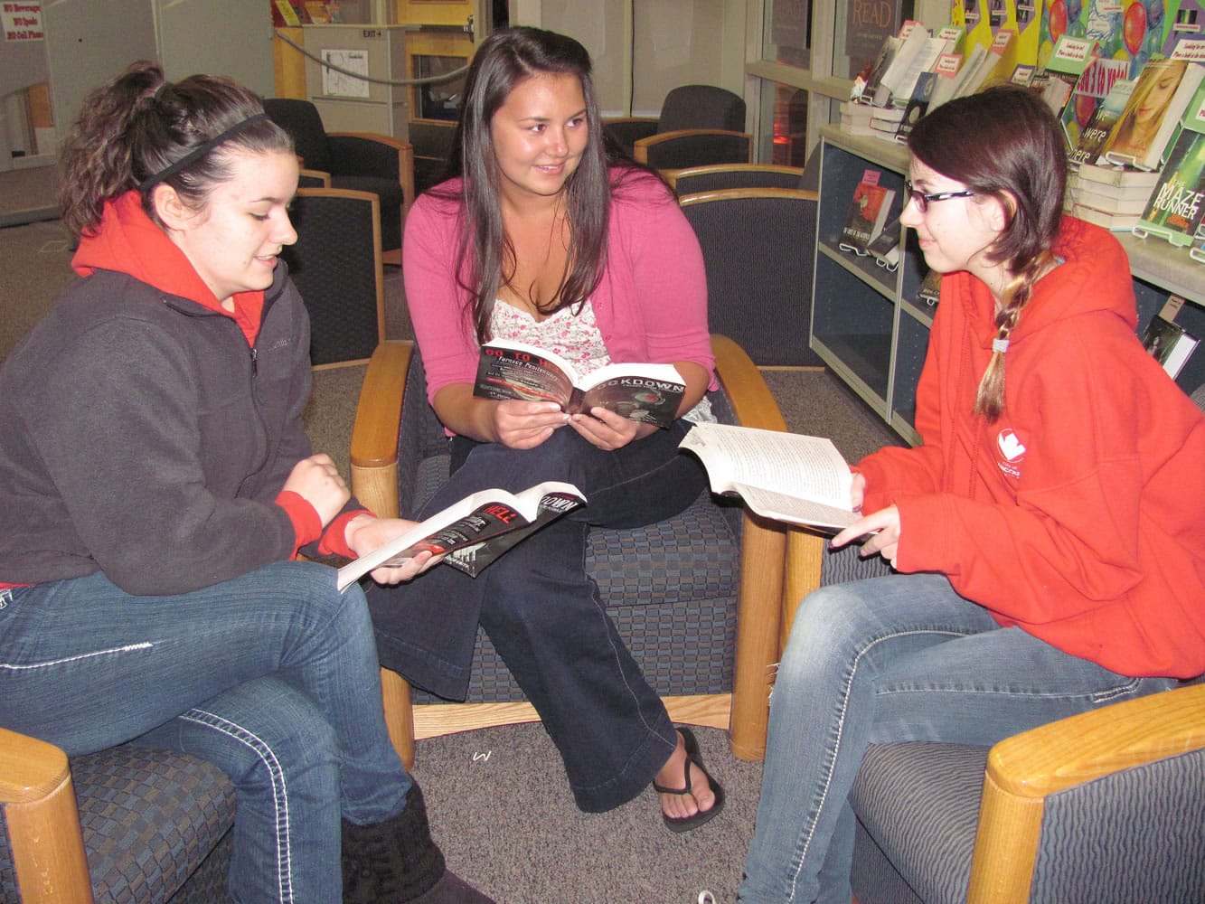 Camas High School students (from left) Ashley Mayfield, Cassidy Hines and Elizabeth Walsh are a part of the Papermaker Book Club.