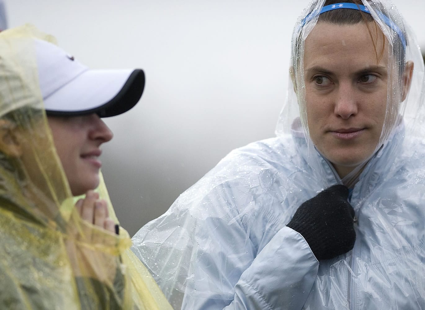 (from left) Jessica Wright, 28, of Beaverton, and Gretchen Strohlein, 33, of Portland, try to keep dry before the start of the annual Vancouver Lake Half Marathon on Sunday January 22, 2012.