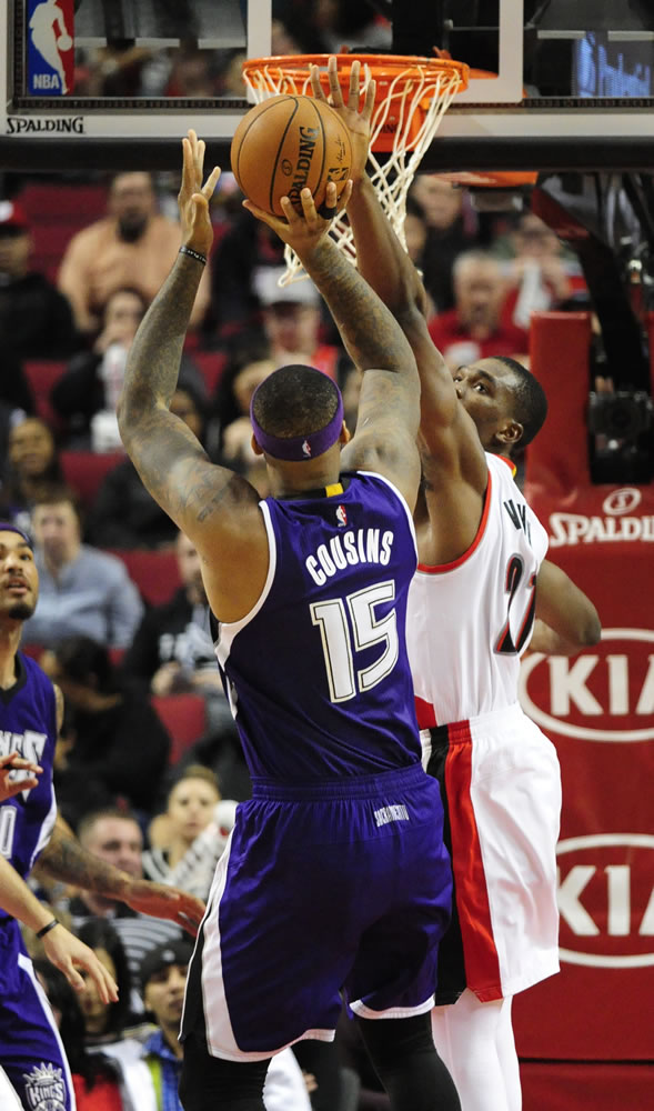 Sacramento Kings center DeMarcus Cousins (15) shoots over Portland Trail Blazers forward Noah Vonleh (21) during the second half of an NBA basketball game in Portland, Ore., Tuesday, Jan. 26, 2016. The Blazers won 112-97.
