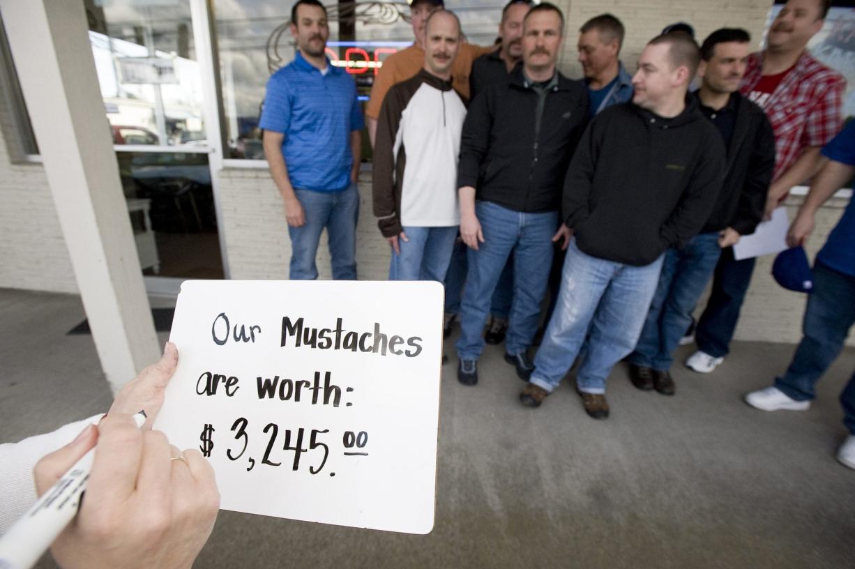 About 20 Clark County Sheriff's deputies gathered to get their moustaches sheared for charity at Bernie and Rollie's Barber Shop in 2010 for the American Cancer Society.