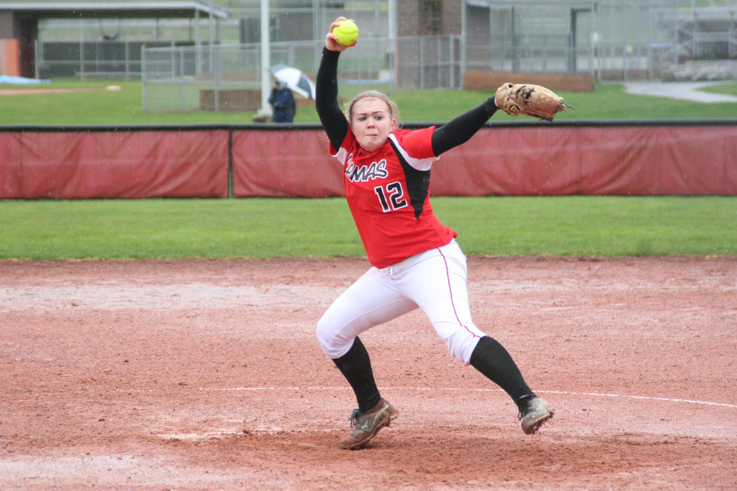 Sarah Nidick winds up a pitch for the Papermakers in the rain Monday, at Camas High School.
