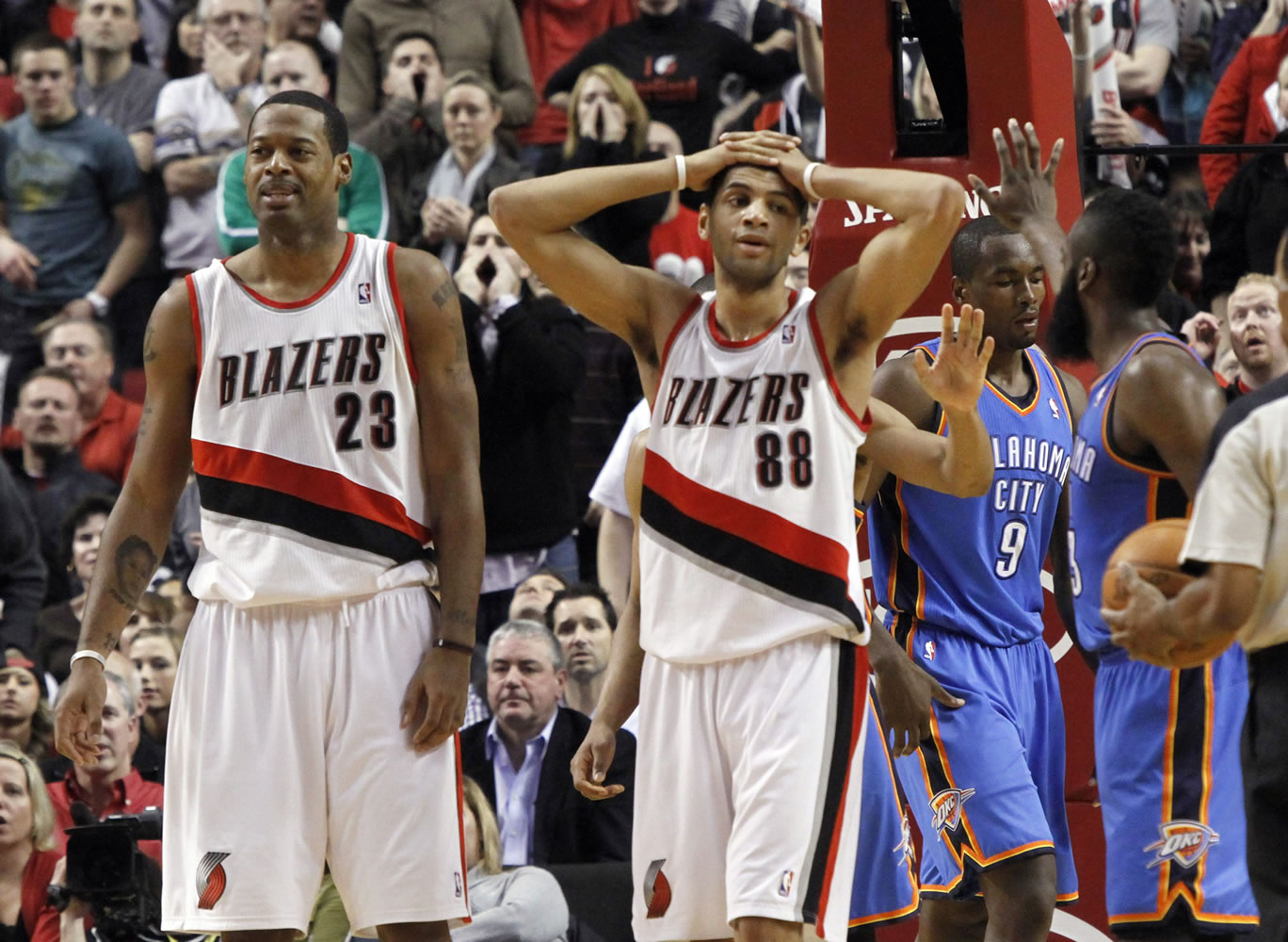 Marcus Camby (23) and Nicolas Batum (88), walk away after the Blazers were called for goaltending in overtime during their game against the Oklahoma City Thunder on Feb. 6.