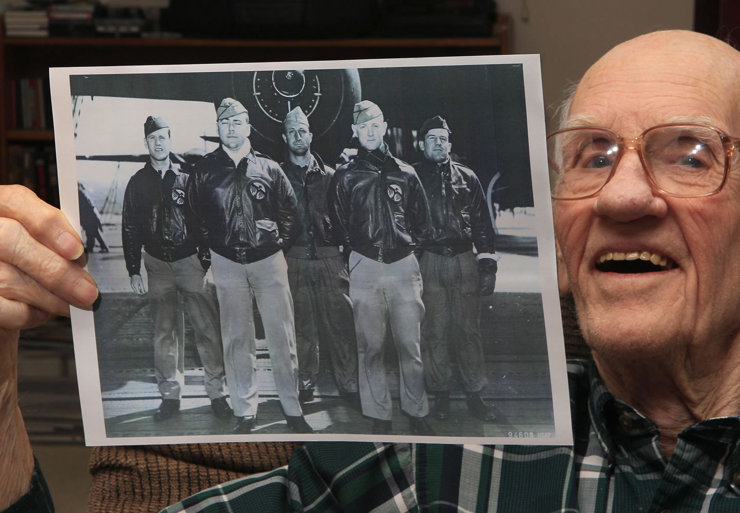 Tom Griffin holds a photo of his B-25 crew -- including a Vancouver airman -- for the April 18, 1942, Doolittle Raid on Japan. Griffin, then a lieutenant, stands at left with, from left, pilot Lt. Harold Watson, Tech. Sgt. Eldred Scott, Lt. James Parker, and Staff Sgt.