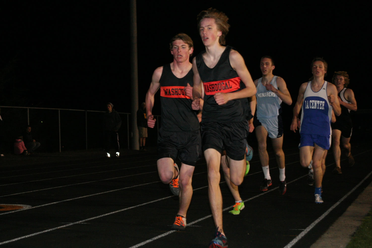 Washougal's Isaac Stinchfield (front) and Sean Eustis (left) push each other in the 3,200-meter run at the Kalama Invitational Friday. Eustis won this event with a time of 9:41.02.