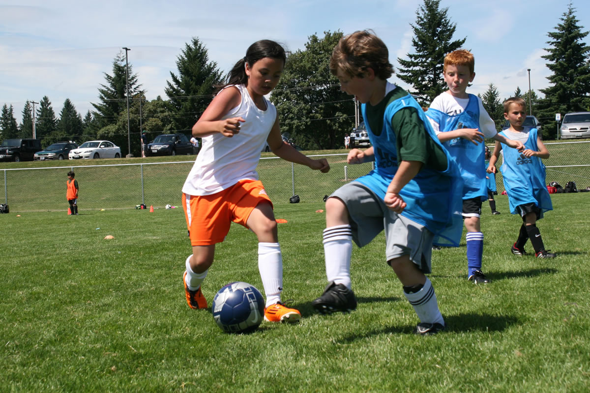 Young soccer players hone their skills at the Portland Timbers Camas-Washougal Camp in the fields behind Doc Harris Stadium.