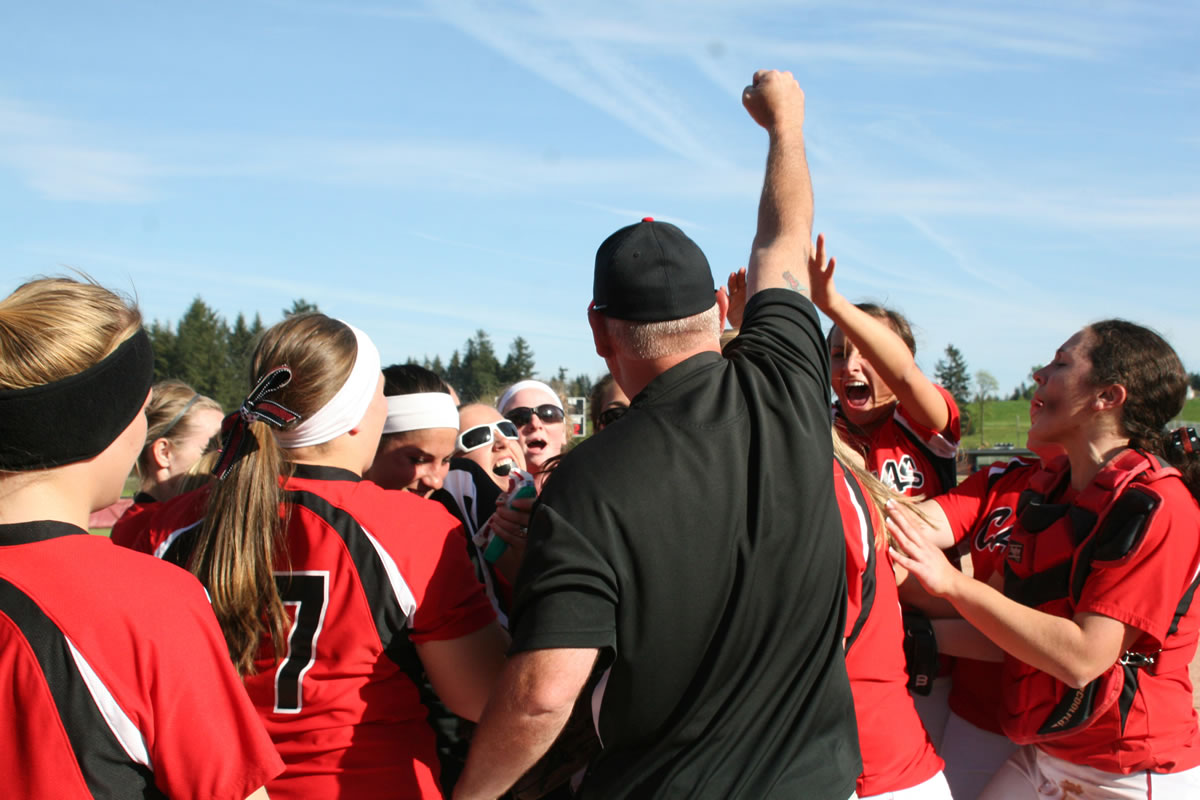 The Papermaker softball players and coaches celebrate after beating Kelso 2-1 Monday, at Camas High School, to clinch their first league championship since 2002.