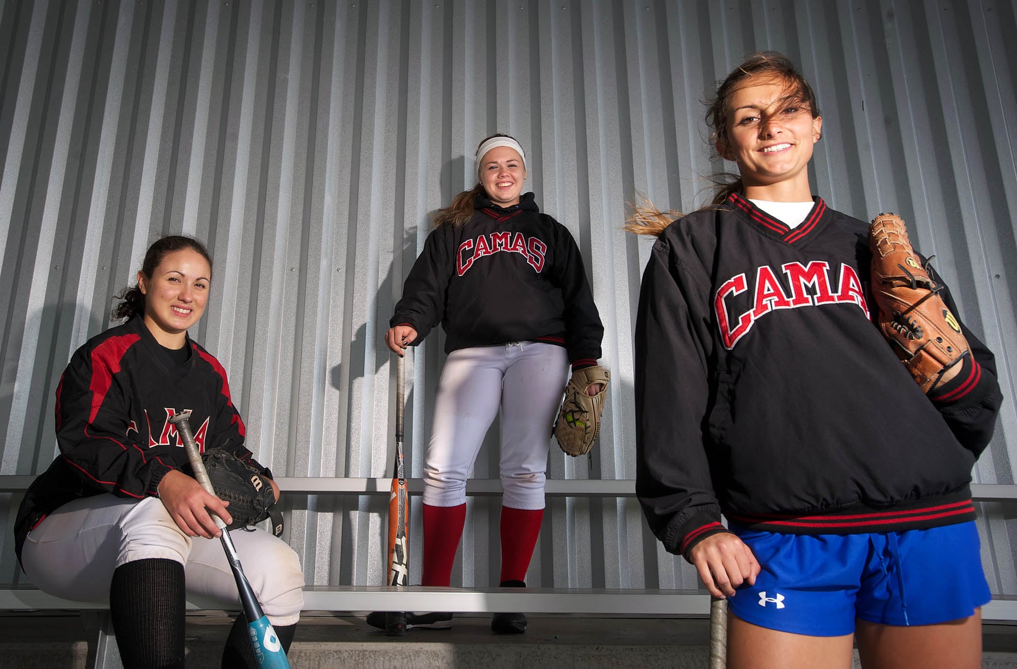 Camas seniors, from left, Mikaela Searight, Sarah Nidick and Cali Mulholland patrol the middle of the field for the Camas softball team.