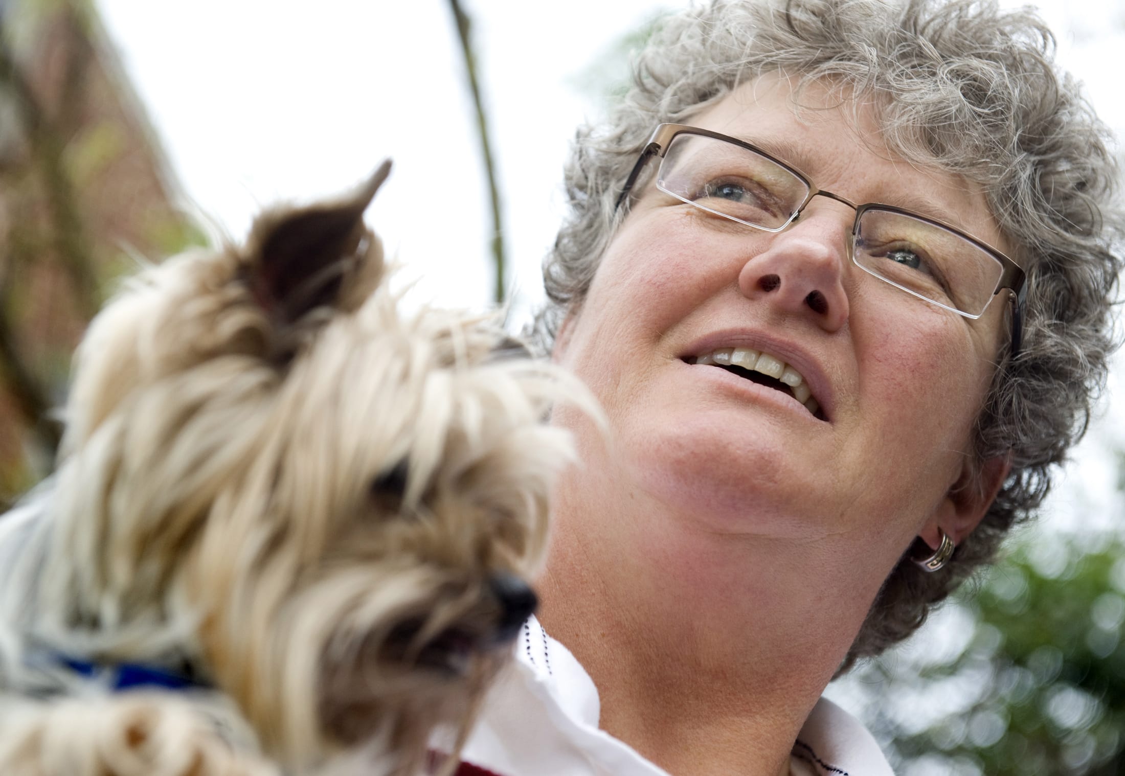 Pet acupuncturist Greta McVey holds a dog, Puff, in her home office in College Park, Md.