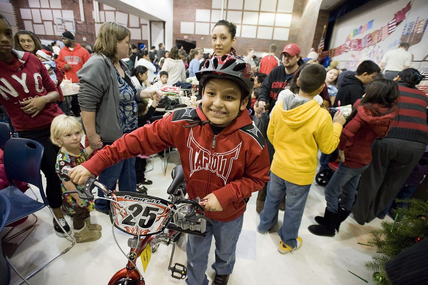 Jose Castaneda scored a new bike at the 2010 holiday party hosted by the Northeast Hazel Dell Neighborhood Association. Last year 800 children attended the community Christmas party. Not only does the party provide gifts for children, but it supplies food boxes for the needy, too.