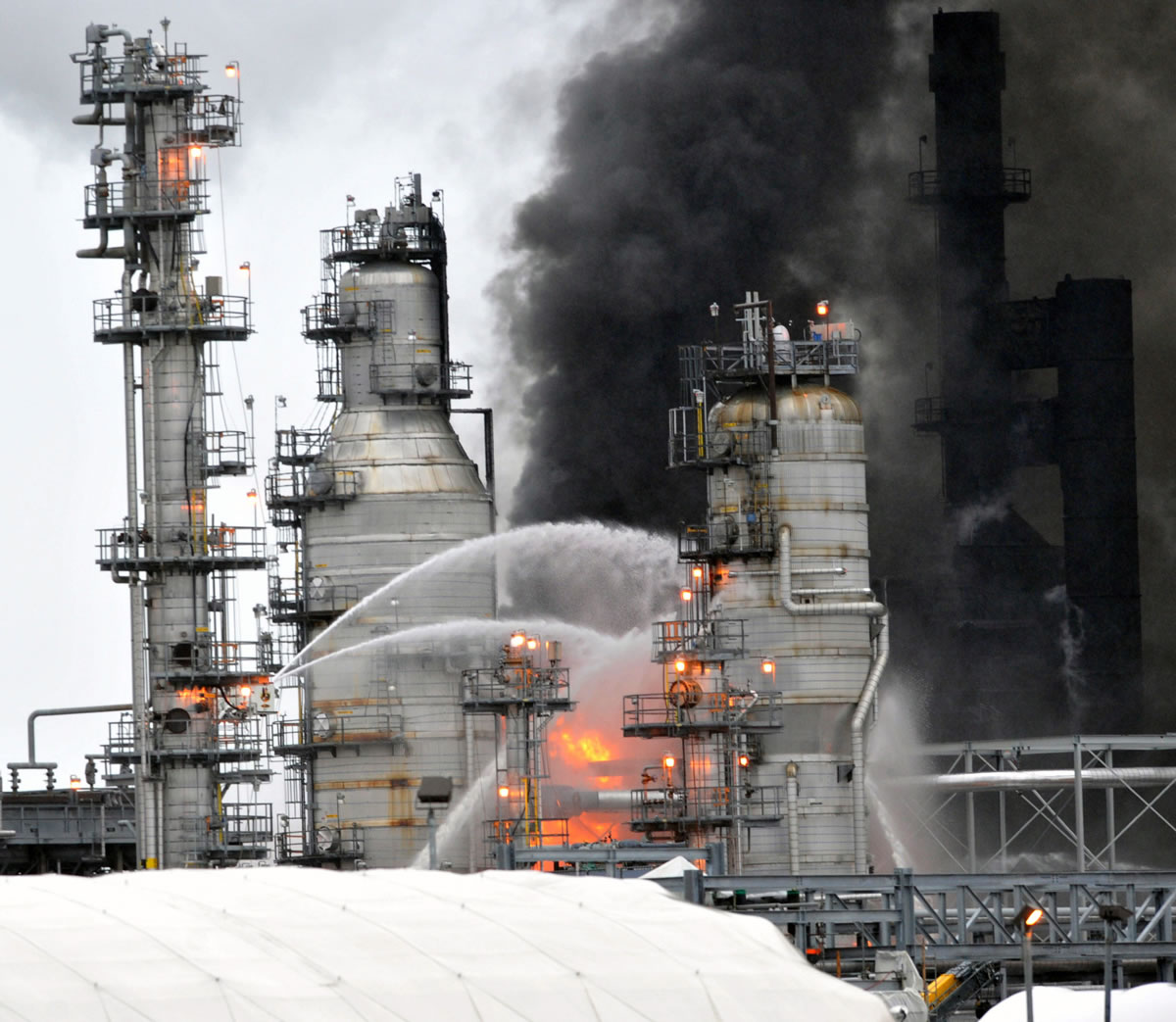 Firefighters spray water at the BP Cherry Point Refinery fire Feb. 17 near Ferndale. Critics are questioning production slowdowns at other West Coast refineries in the wake of the fire. Sen.